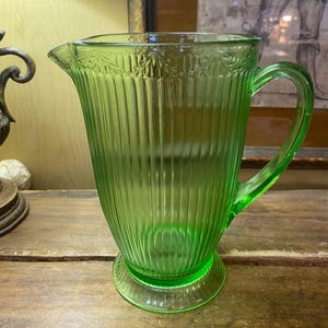 Ribbed Green Depression Glass Pitcher. Ornate Ivy Vine pattern. Light Green frosted water pitcher. 8&quot;H x 8&quot;W.