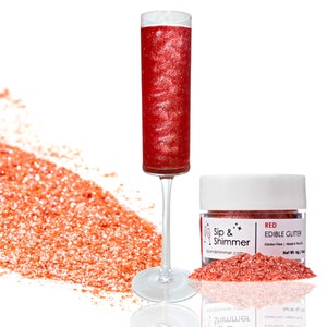 May include: A small jar of red edible glitter with the text "Sip & Shimmer" and "RED EDIBLE GLITTER" on the label. The glitter is also shown in a champagne flute.