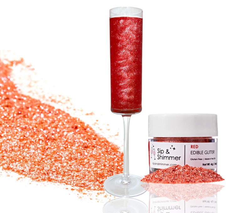 May include: A small jar of red edible glitter with the text "Sip & Shimmer" and "RED EDIBLE GLITTER" on the label. The glitter is also shown in a champagne flute.