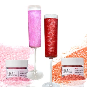 May include: Two glass champagne flutes filled with pink and red edible glitter. Two small jars of edible glitter labeled "Sip & Shimmer" with the colors "Blush" and "Red".