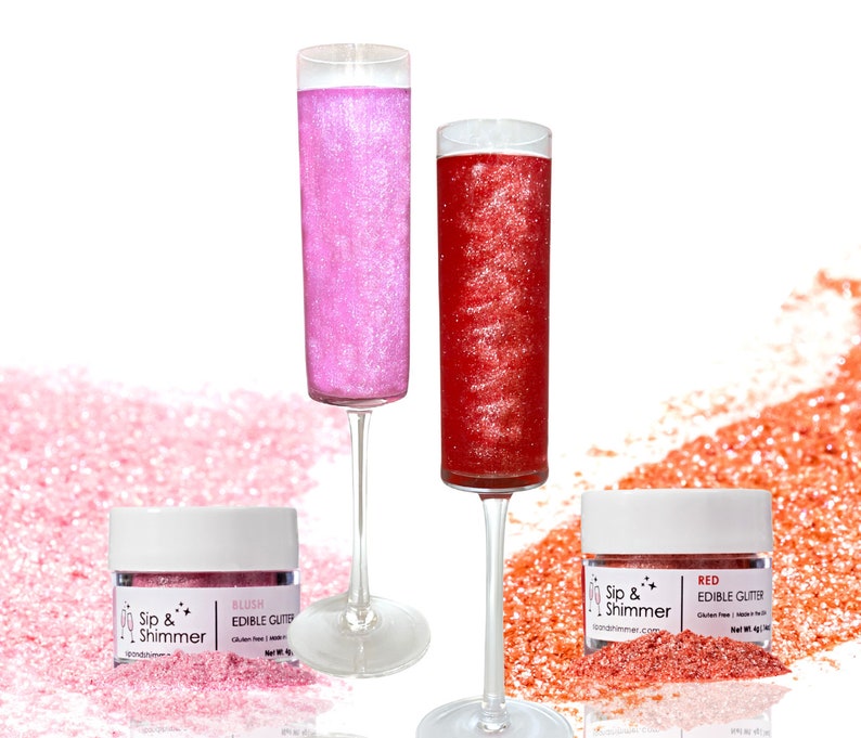 May include: Two glass champagne flutes filled with pink and red edible glitter. Two small jars of edible glitter labeled "Sip & Shimmer" with the colors "Blush" and "Red".