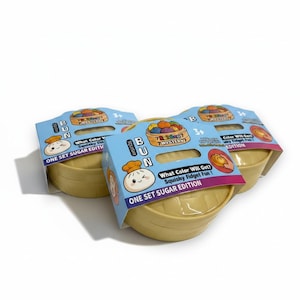 May include: Three squishy toy sets, each with a light blue label featuring a cartoon bun character and the text "BUN". The sets are in a light yellow container. The labels read "What Color Will Get? Squishy Fidget Fun!"