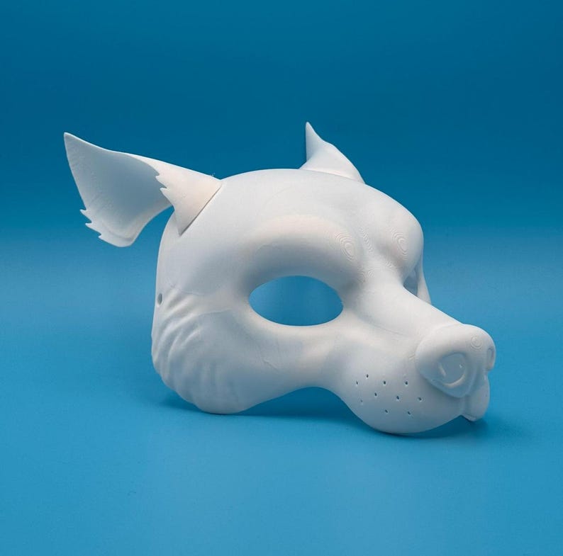 May include: A white, unpainted, plastic wolf mask with ears. The mask has a detailed snout and eye holes.
