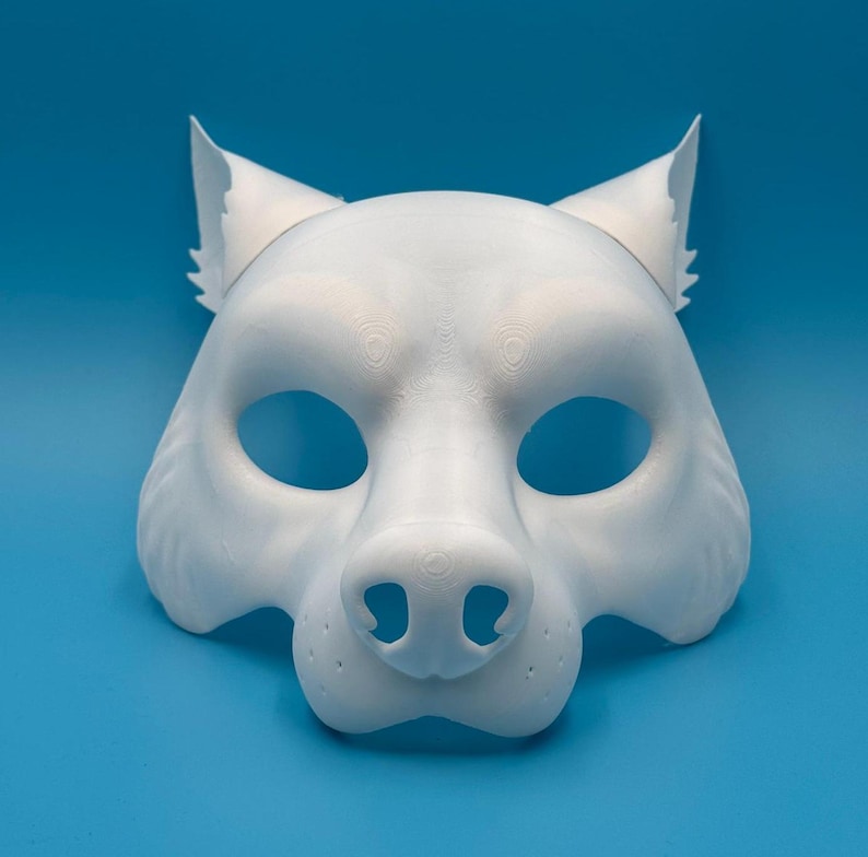 May include: A white wolf mask with a detailed snout and ears. The mask is made of a smooth, plastic-like material.