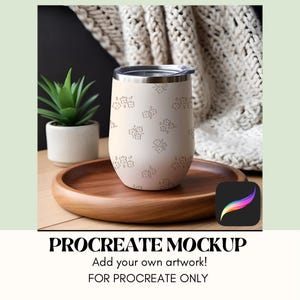 May include: A beige insulated tumbler with a floral pattern, a silver rim, and a black lid sits on a wooden tray. The tumbler is next to a small potted plant and a Procreate Mockup graphic.