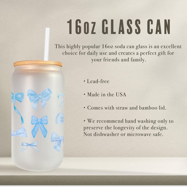 May include: A frosted glass 16oz soda can with a bamboo lid and a blue bow design. It comes with a straw and is lead-free.  The text on the image reads "16oz GLASS CAN".