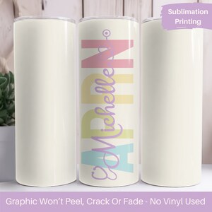 May include: Three white sublimation tumblers with a colorful design on the middle tumbler. The design features the name "April" in pastel colors with the word "Michelle" written in purple script. The text "Sublimation Printing" is in the top right corner of the image. The text "Graphic Won't Peel, Crack Or Fade - No Vinyl Used" is at the bottom of the image.