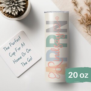 May include: A 20 ounce stainless steel tumbler with a white background and colorful text that reads "2023 Nurse" in a cursive font. The text is in shades of blue, green, pink, and orange.