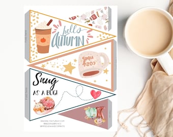 May include: Printable autumn-themed banner with four flags. The flags feature illustrations of a cup of coffee, a mug of hot chocolate, a snail, and a pumpkin. The text on the flags reads "hello autumn", "snug as a bug", and "socia cozy".
