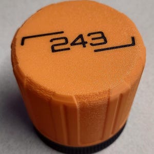 May include: An orange knob with the number "243" printed in black. The knob has a ridged design around the sides and a black base. The top of the knob has a textured surface.