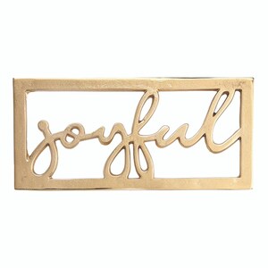 May include: A gold-colored metal sign with the word "joyful" in a cursive font. The word is within a rectangular frame. The sign is a decorative item.
