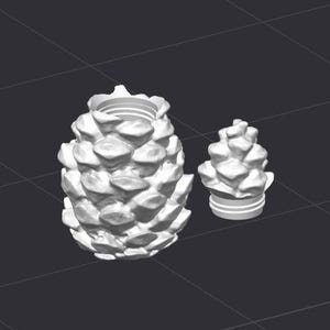 May include: Two white, pine cone-shaped objects. The larger one is a container with a wide opening and a textured surface. The smaller one is a lid or stopper, also pine cone-shaped, with a striped base.