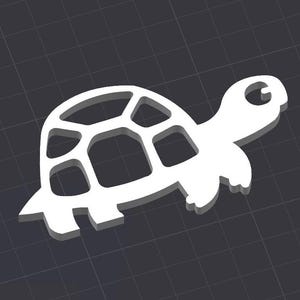 May include: A white, cutout, 3D turtle shape. The turtle has a detailed shell with a geometric pattern.