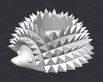 Puede incluir: Una figurita de erizo geométrica blanca con un diseño de púas triangulares. La figurita está hecha de un material blanco liso y tiene una superficie texturizada detallada.