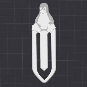 May include: A white penguin bookmark with a black beak and eyes. The bookmark is shaped like a penguin sitting on a white paperclip.