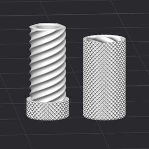 May include: Two white cylindrical objects. One has a spiral design, the other has a diamond pattern. Both have a base with a diamond pattern. The objects are on a dark gray surface.
