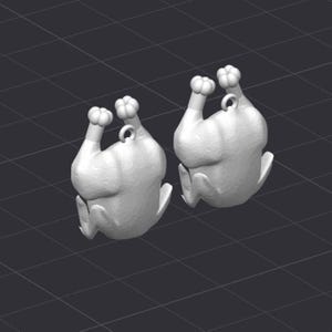 May include: Two white, 3D-rendered chicken-shaped pendants. Each pendant has a loop at the top for hanging and a detailed design. The background is a dark gray grid pattern.