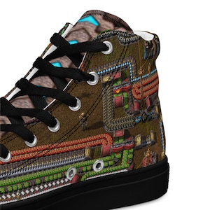 May include: High-top canvas shoes with a black sole and laces. The shoes feature a colorful design of a video game map with green, red, and brown details.