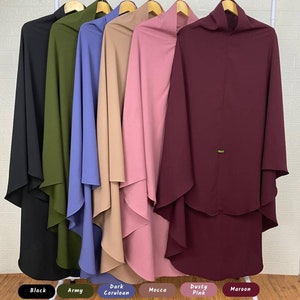 May include: Six different colored hooded scarves hanging on a rack. The colors are black, army green, dark cerulean, mocha, dusty pink, and maroon.