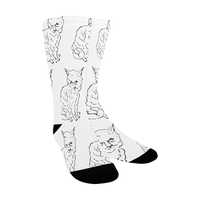 May include: White socks with a black and white line drawing of a cat repeated all over the sock.