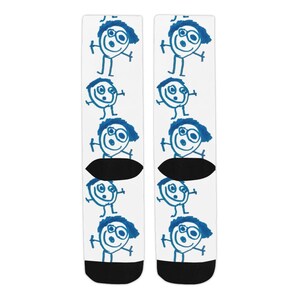 May include: A pair of white socks with a blue stick figure pattern. The stick figure has a blue face with a smile and glasses.
