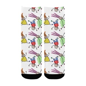 May include: A pair of white socks with a colorful pattern of stick figures. The figures are in various poses, including jumping and standing. The socks have black toe and heel.
