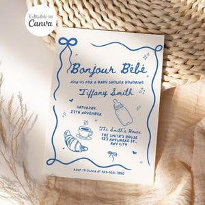 May include: Blue and white baby shower invitation with the text "Bonjour Bébé" and "Tiffany Smith". The invitation includes a baby bottle, a croissant, and a cup of coffee.