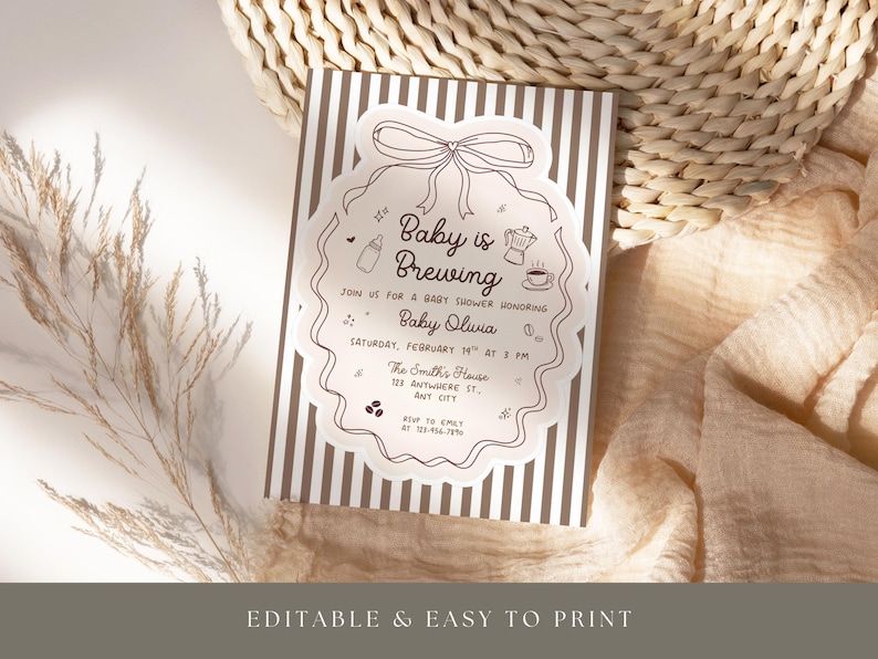 May include: A baby shower invitation with a brown and white striped background. The invitation features a decorative border with the text "Baby is Brewing" and event details. The invitation is surrounded by a neutral-toned background.