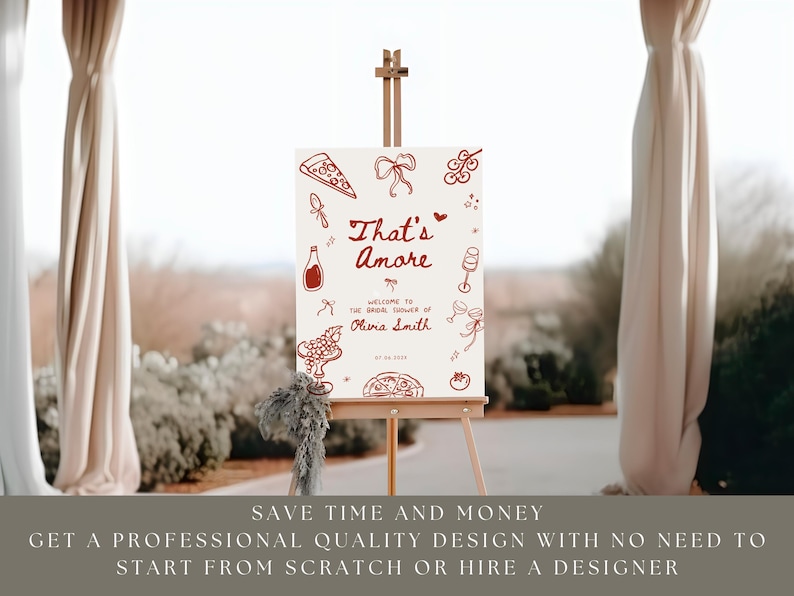 May include: A sign on an easel with the words "That's Amore" in red script, with illustrations of pizza, wine, and grapes. The sign welcomes guests to a bridal shower. The background is a blurred outdoor scene.