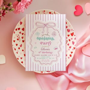 May include: A pink and white striped invitation for a pajama party, featuring a decorative border and bow. The invitation is on a plate decorated with red hearts, surrounded by pink hearts and flowers. The text reads "Spajama Party".