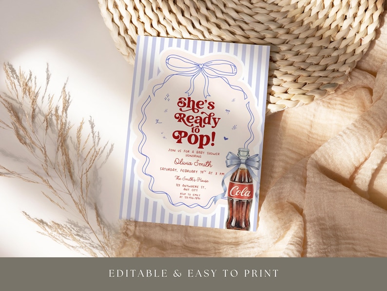 May include: A baby shower invitation with a vintage design. The invitation features the text "She's Ready to Pop!" in red and white, with a drawing of a cola bottle. The background has blue and white stripes.