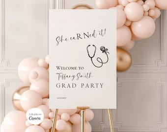 May include: A white sign on a gold easel with the text "She earned it!" and "Welcome to Tiffany Smith GRAD PARTY". A black stethoscope graphic is above the text. The background includes pink and gold balloons.