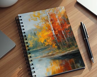 May include: A spiral-bound notebook featuring an oil painting of an autumn forest landscape with vibrant yellow and orange trees reflected in a calm lake. The cover art displays a dense woodland scene with visible brushstrokes and a black metal coil.