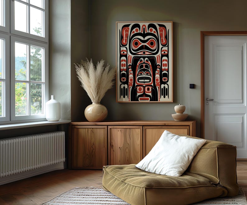 May include: A wooden cabinet with two doors and a white cushion on a brown floor. A large framed print of a black and red stylized design hangs on a green wall.