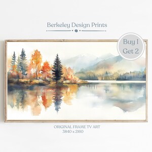 May include: Watercolor painting of a lake scene with fall foliage and mountains in the background. The lake is reflecting the trees and sky. The painting is framed and has the text "Berkeley Design Prints" and "Buy 1 Get 2" on it.