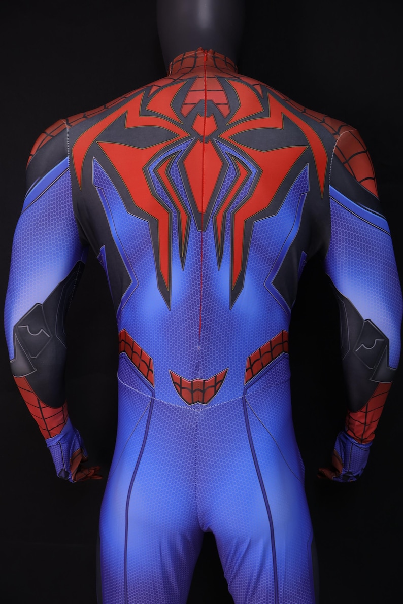 May include: Blue and red superhero costume with a spider-web design. The back of the suit features a large red spider emblem and black accents. The costume is form-fitting and appears to be made of a flexible material.