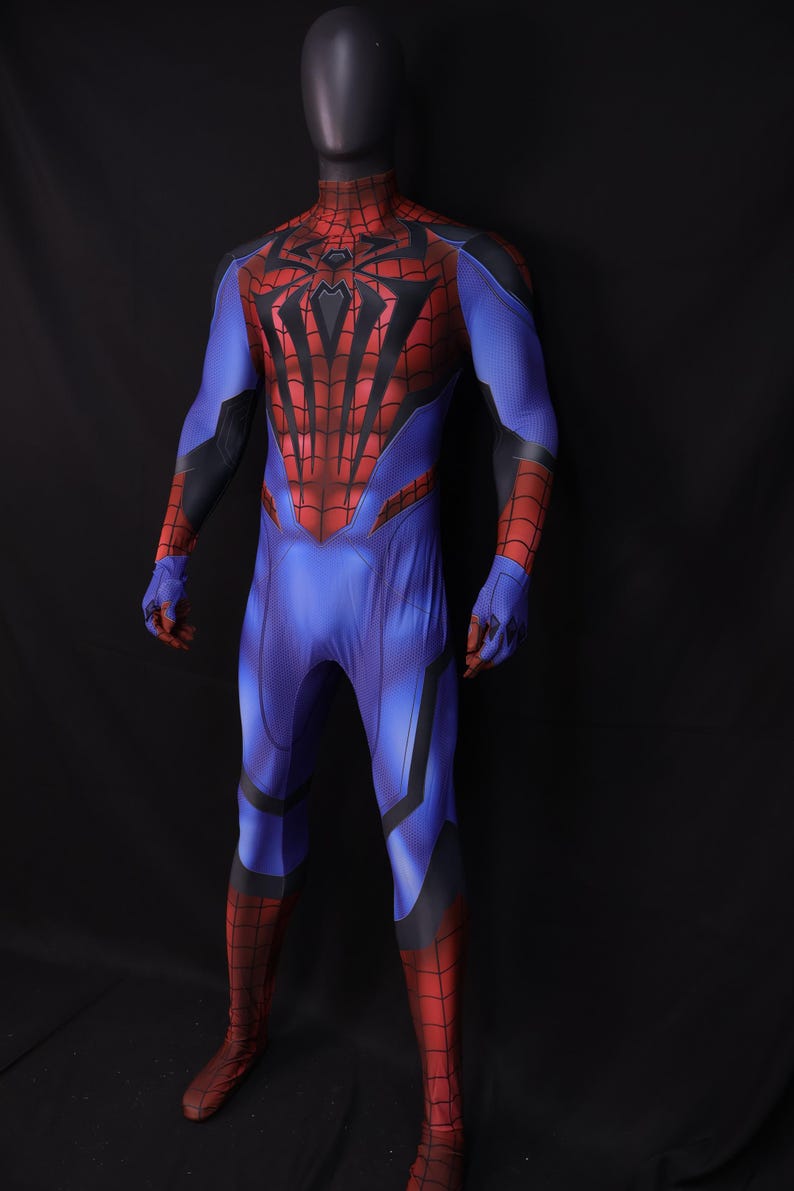 May include: A full-body superhero costume in blue, red, and black, displayed on a mannequin. The costume features a spiderweb design on the chest and a spider emblem. The suit has a form-fitting design with details on the arms and legs.