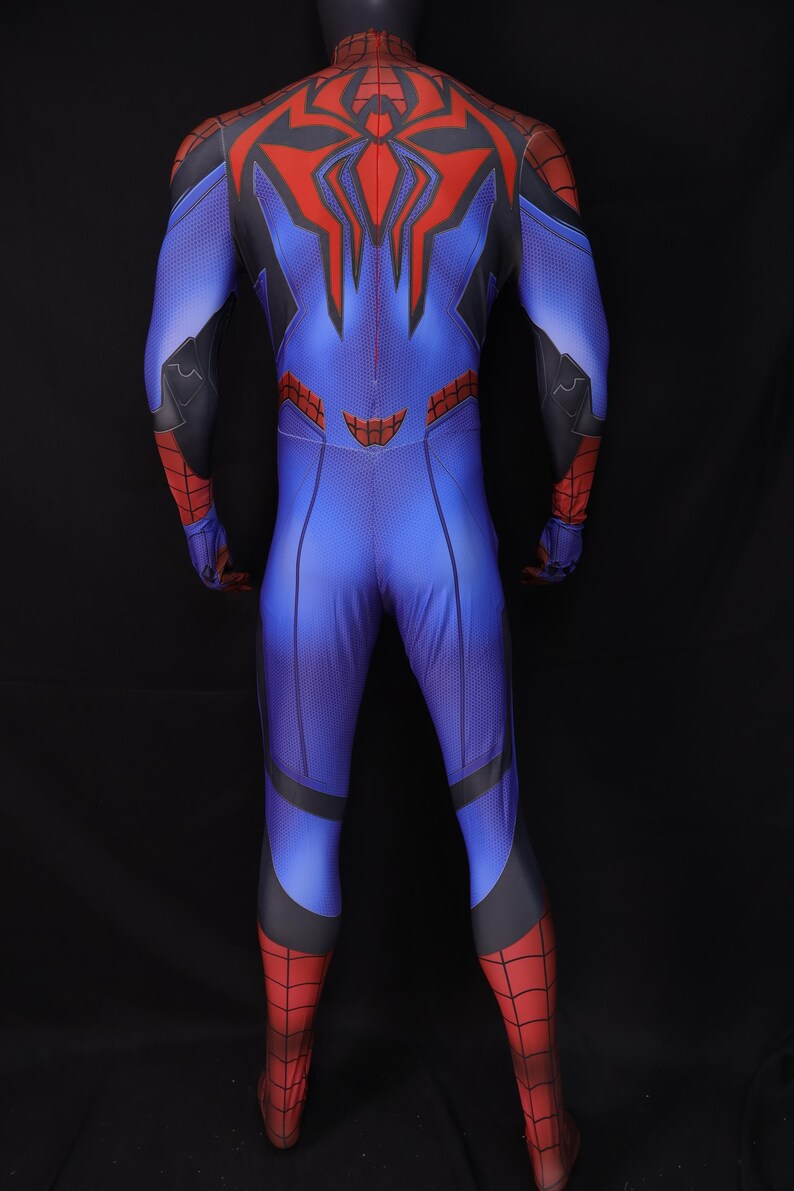 May include: Blue and red superhero costume with a spider-themed design. The full-body suit features a blue base with red accents on the arms, legs, and back. A large red spider emblem is on the back.