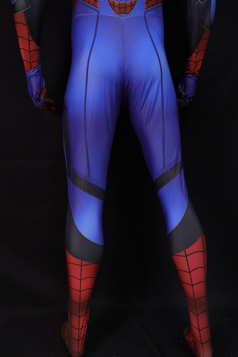 May include: Blue and red superhero costume with a textured pattern. The costume features a blue torso and legs with black accents, transitioning to red legs and feet. The gloves and upper arms are red and black.