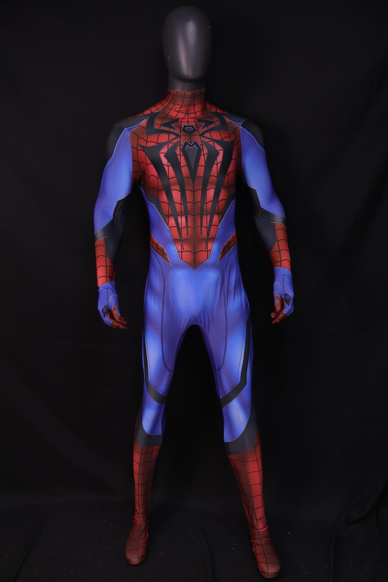 May include: A full-body Spider-Man costume on a mannequin. The suit is primarily blue with red accents on the chest, arms, and legs. Black webbing details and a spider emblem are visible on the chest.