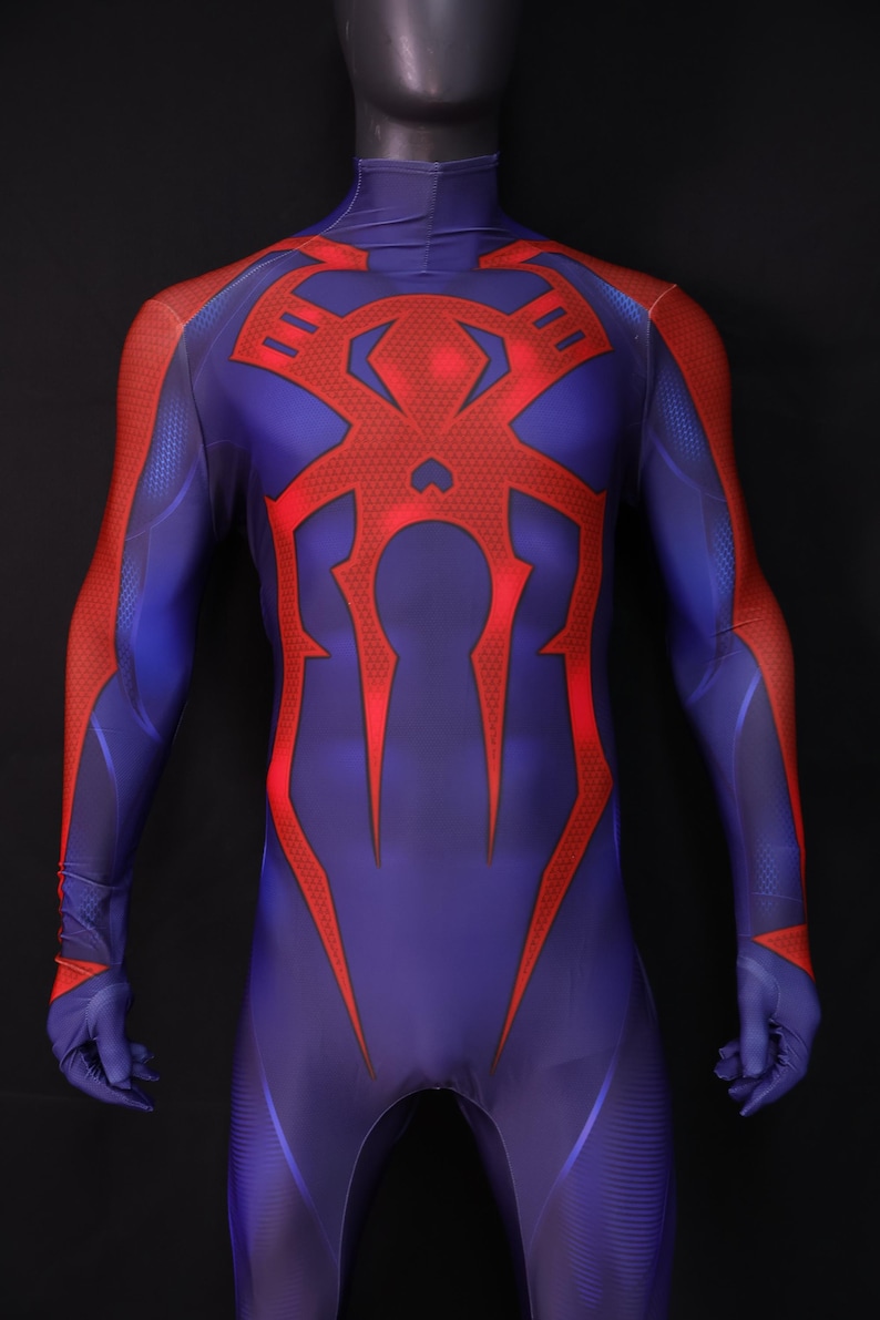 May include: A full-body superhero costume in shades of blue and red. The suit features a large red spider emblem on the chest and red accents on the arms and legs. The costume is displayed on a mannequin.