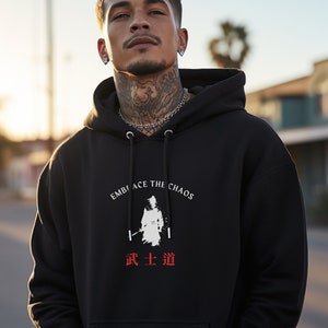 May include: Black hooded sweatshirt with a white graphic of a samurai warrior and the text "Embrace the Chaos" in white and "武士道" in red.