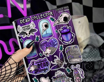 May include: A sticker sheet titled DEAD COLLECTOR featuring various illustrations including a bird skull in a glass dome, a purple beetle, an opossum, a book labeled BONES AND TAXIDERMY, a moth, and text reading I collect DEAD THINGS.