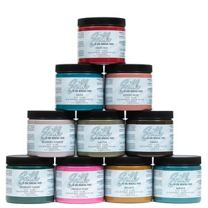 May include: A pyramid display of ten 8-ounce jars of all-in-one mineral paint in various colors, including fiery sky, oasis, desert rose, cactus, ember, midnight green, prickly pear, olive, and morace. The jars are labeled with the brand name "Silk".