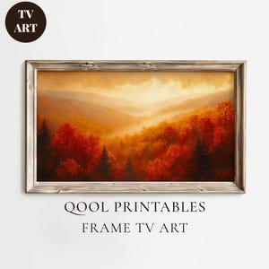 Könnte beinhalten: Ein gerahmter Landschaftsdruck mit einer lebendigen Herbstszene. Das Kunstwerk zeigt eine Bergkette mit Bäumen in Rot-, Orange- und Grüntönen. Der Druck trägt die Aufschrift "QOOL PRINTABLES FRAME TV ART" und ist vor einem weißen Hintergrund platziert.