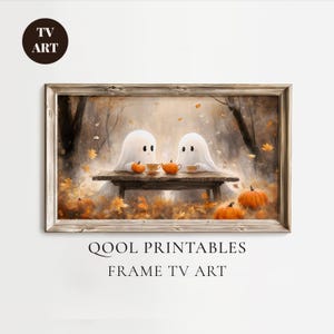 May include: A framed print featuring two cartoon ghosts at a table with pumpkins and teacups. The artwork has a warm color palette of orange, brown, and beige, with the text "QOOL PRINTABLES FRAME TV ART" at the bottom.