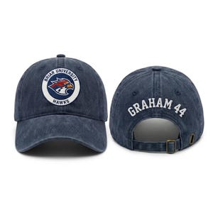 May include: A navy blue baseball cap with the text "Briar University Hawks" on the front and "Graham 44" on the back. The cap features a curved brim and an adjustable strap.