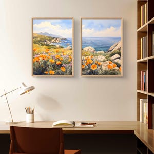 May include: Two framed watercolor paintings depicting a coastal landscape with orange wildflowers in the foreground and a blue ocean in the background.