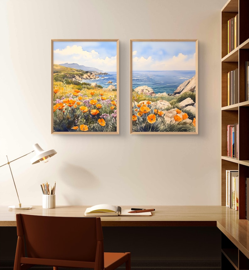 May include: Two framed watercolor paintings depicting a coastal landscape with orange wildflowers in the foreground and a blue ocean in the background.