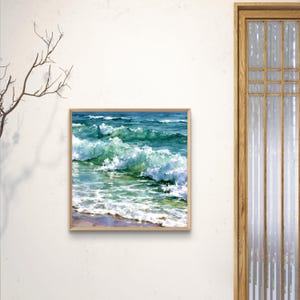 May include: A square framed painting depicting ocean waves crashing towards a sandy shore. The artwork features vibrant shades of turquoise, deep blue, and white sea foam, capturing the movement of water with visible brushstrokes and light.